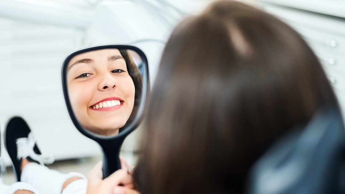 Prosthodontist Patient looking in Mirror