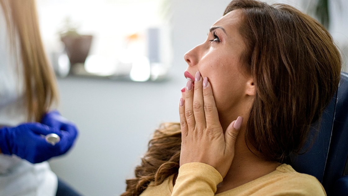 Woman with toothache at dentist